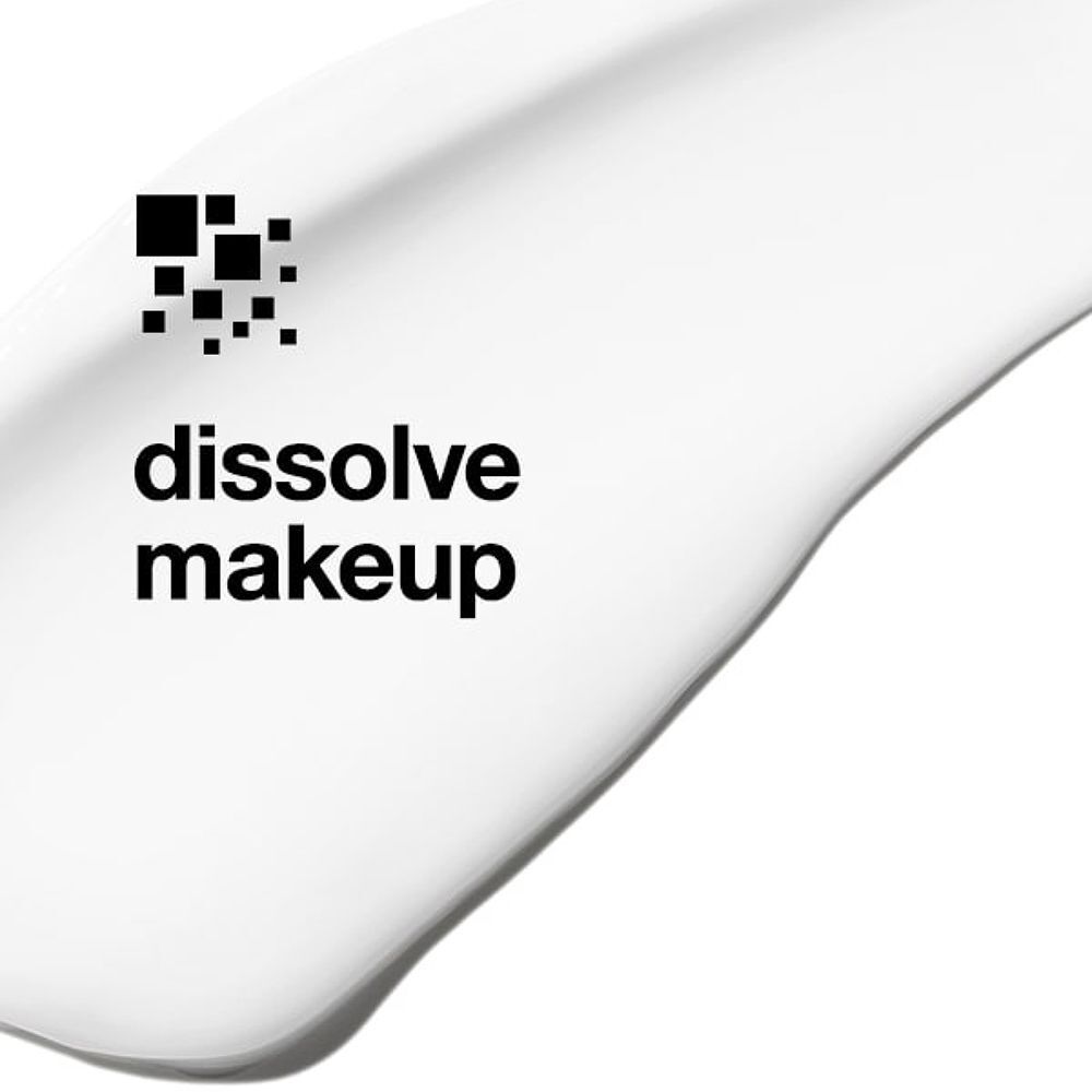 Witte crème met de tekst "dissolve makeup" en een symbool van zwarte vierkanten.