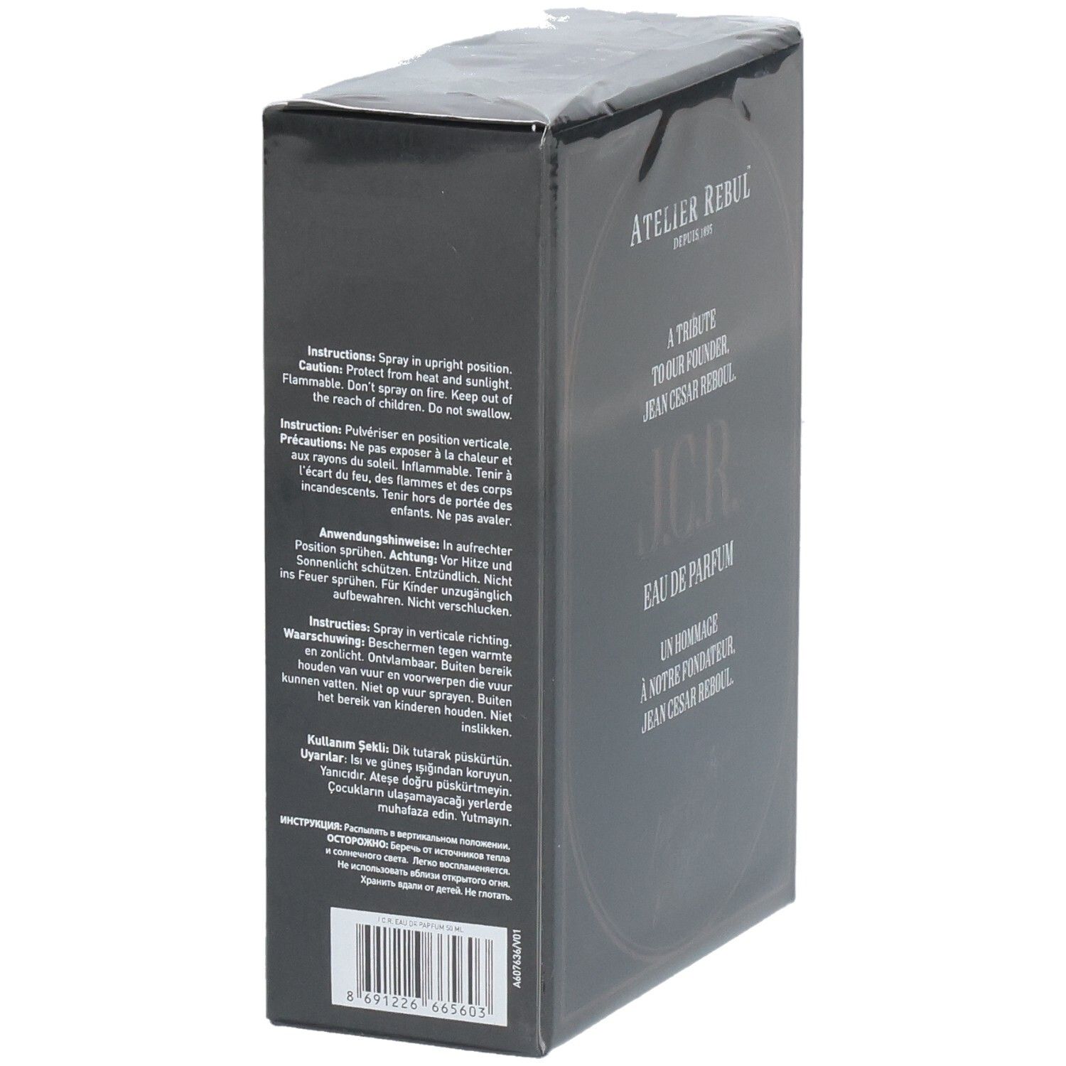 Boîte de parfum noire avec avertissements et instructions en plusieurs langues.