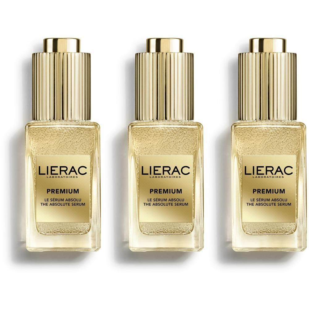 Drie flacons met gouden doppen en etiketten. Opschrift: Lierac Premium Le Sérum Absolu.