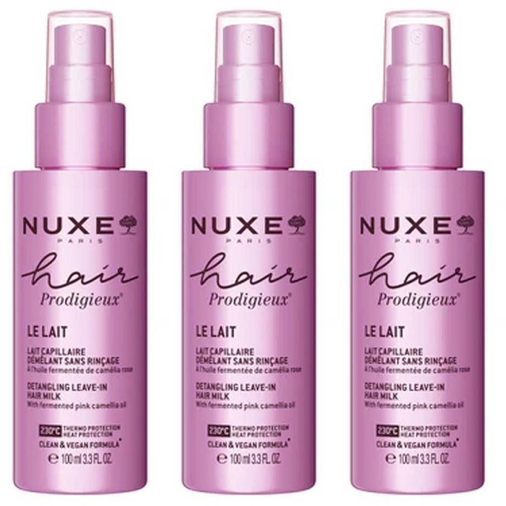 Trois flacons roses avec vaporisateur. Inscription: Nuxe Hair Prodigieux, Le Lait, Detangling Leave-in Hair Milk.