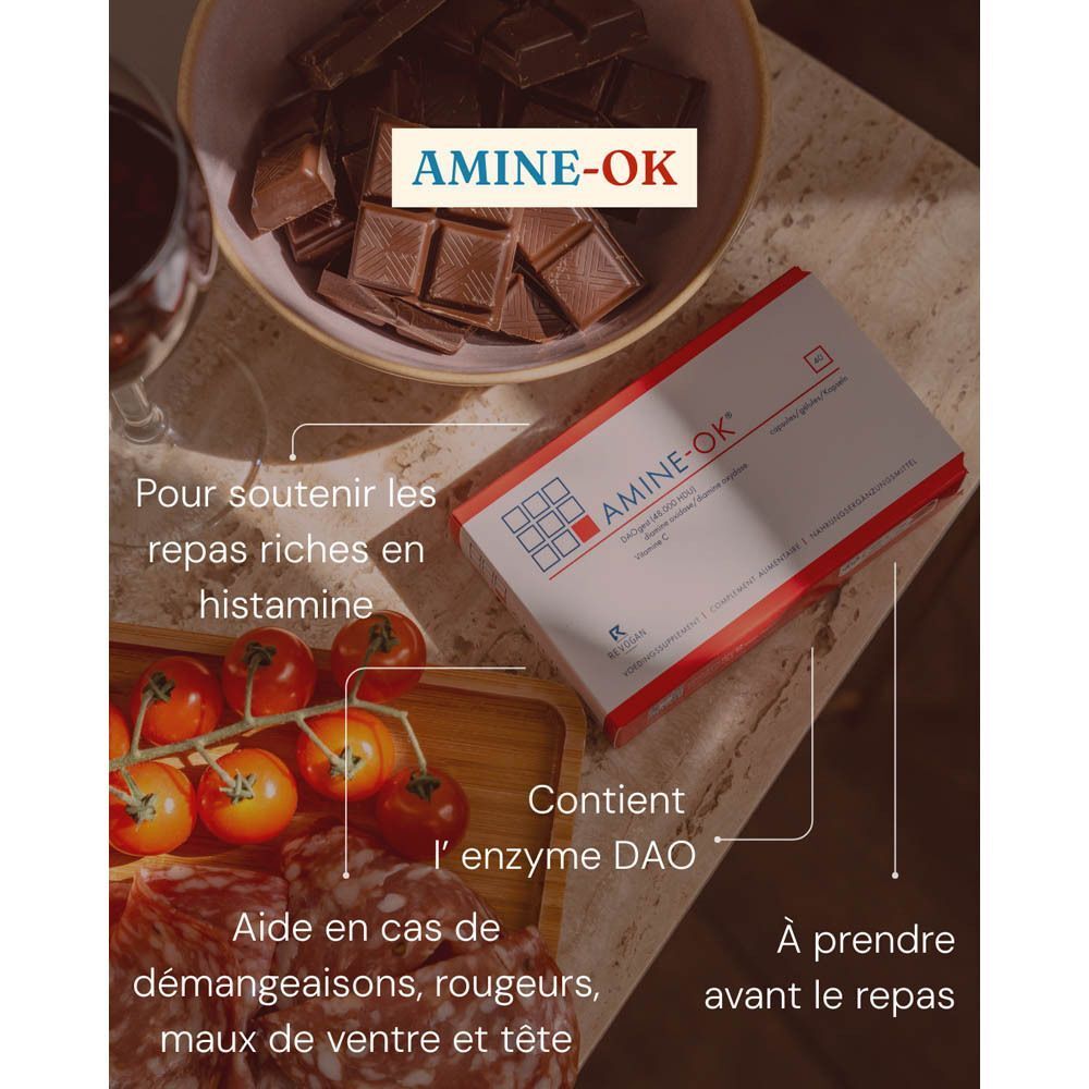 Boîte AMINE-OK avec des morceaux de chocolat, des tomates et de la charcuterie.