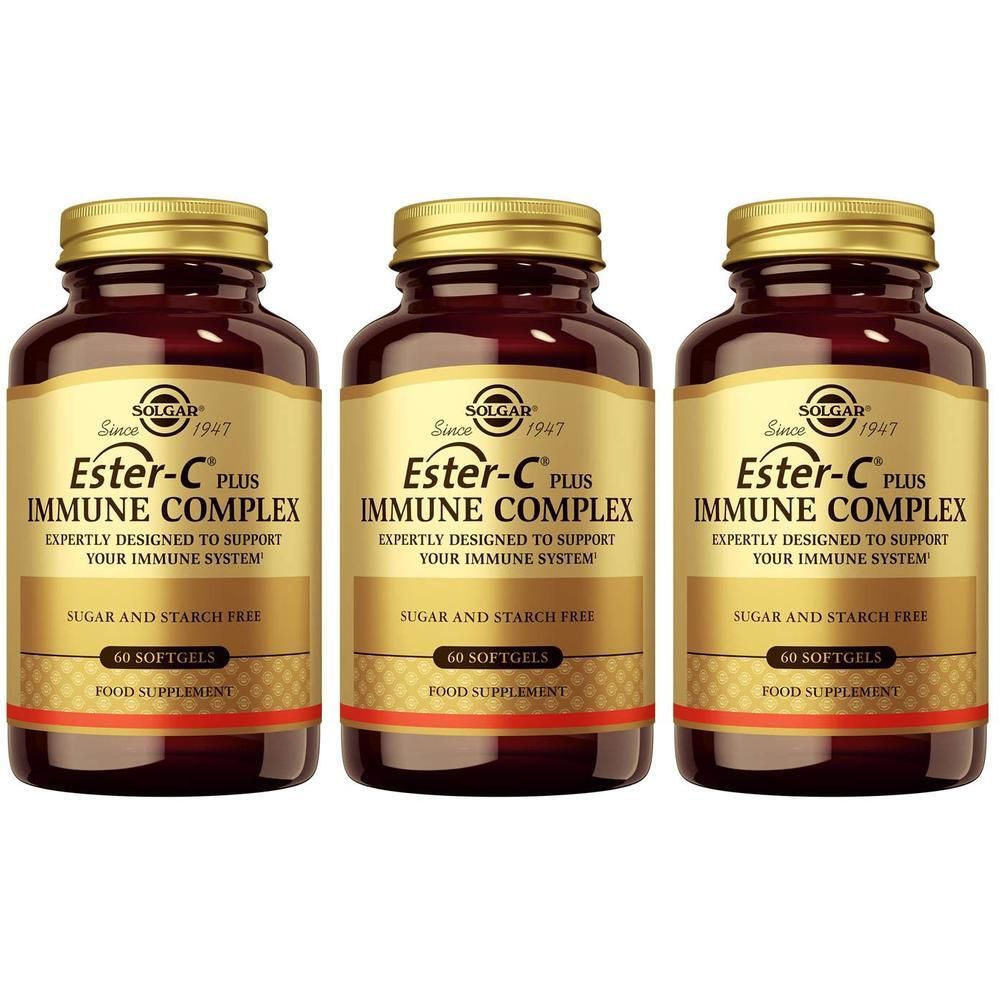 Drie flessen Solgar Ester-C Plus Immune Complex. Bruine glazen flessen met gouden doppen en etiketten.