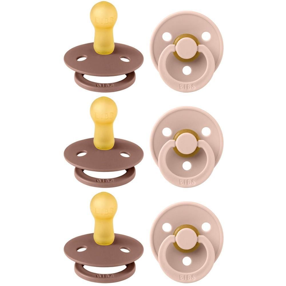 Six tétines, deux couleurs : marron et rose. Forme ronde, tétine jaune. Anneau avec inscription.