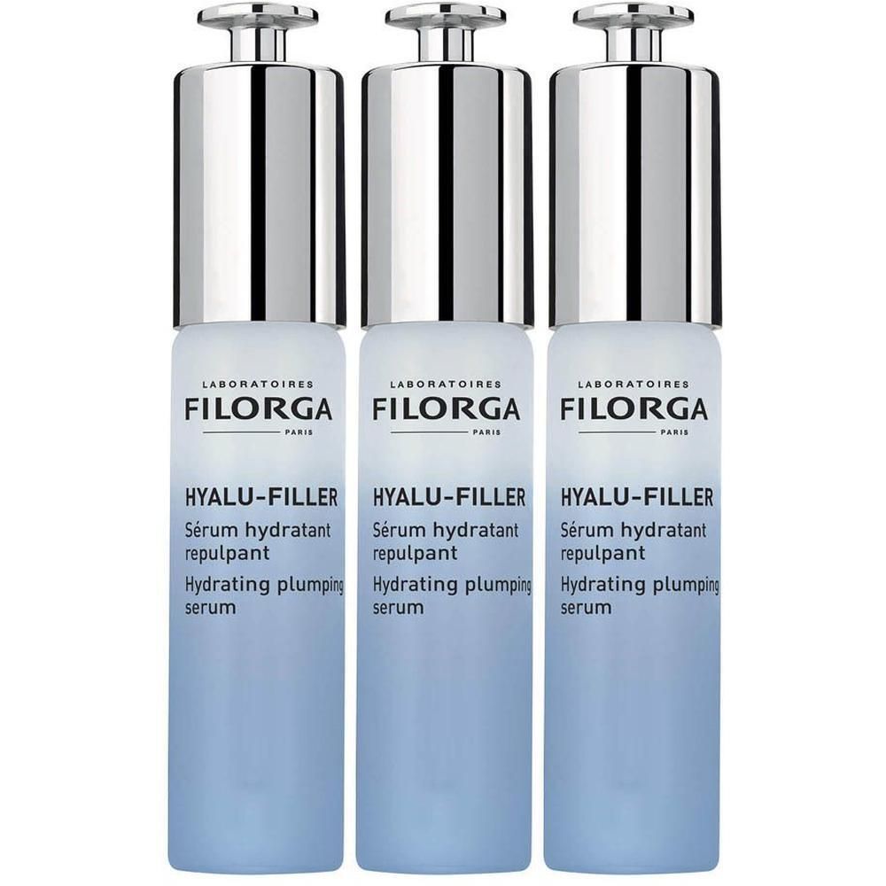 Drie flacons Filorga HYALU-FILLER serum. Blauwe flacons met zilveren pompen. Franse tekst.