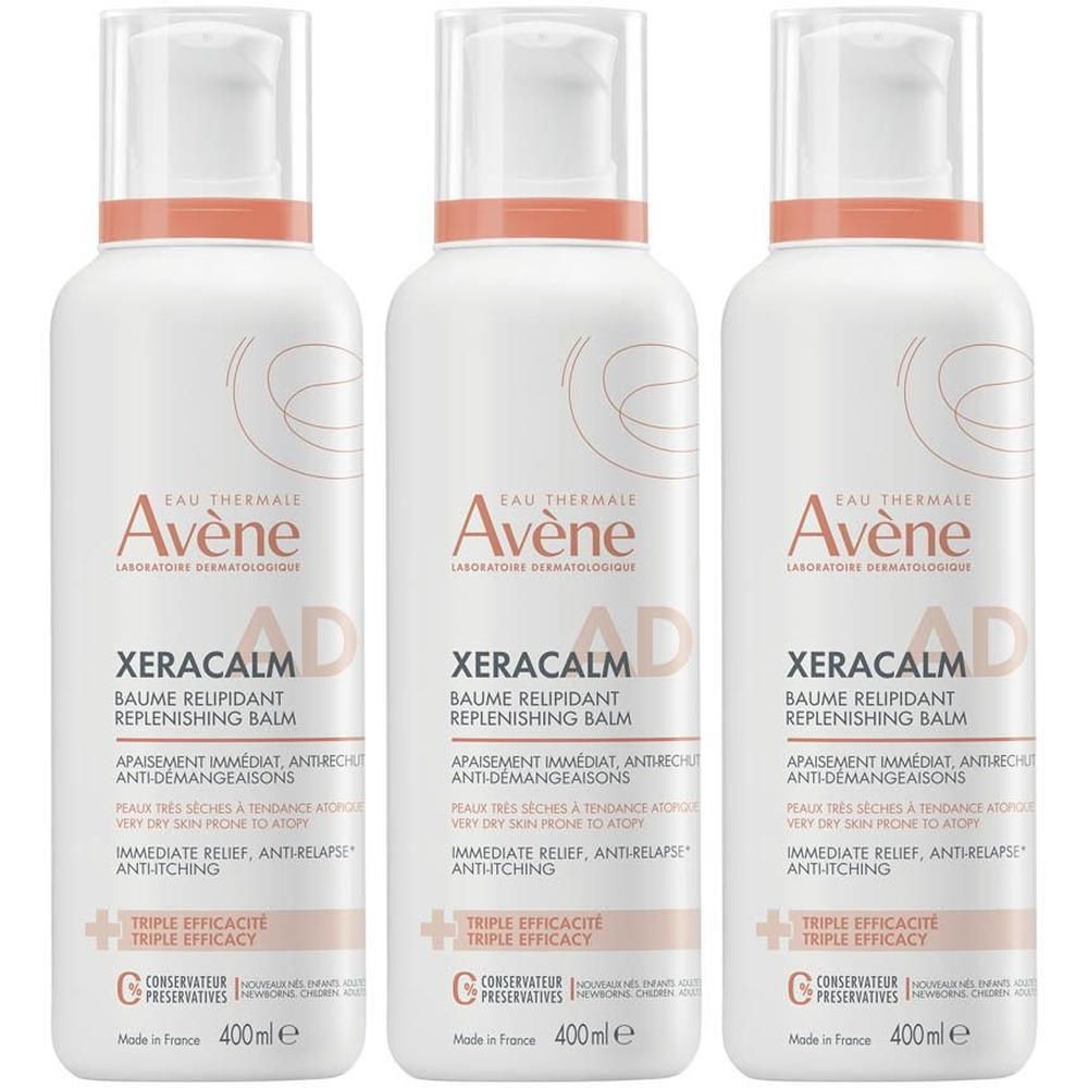 Trois flacons Avène Xeracalm A.D. Baume Relipidant. Flacons blancs avec accents orange et informations produit.