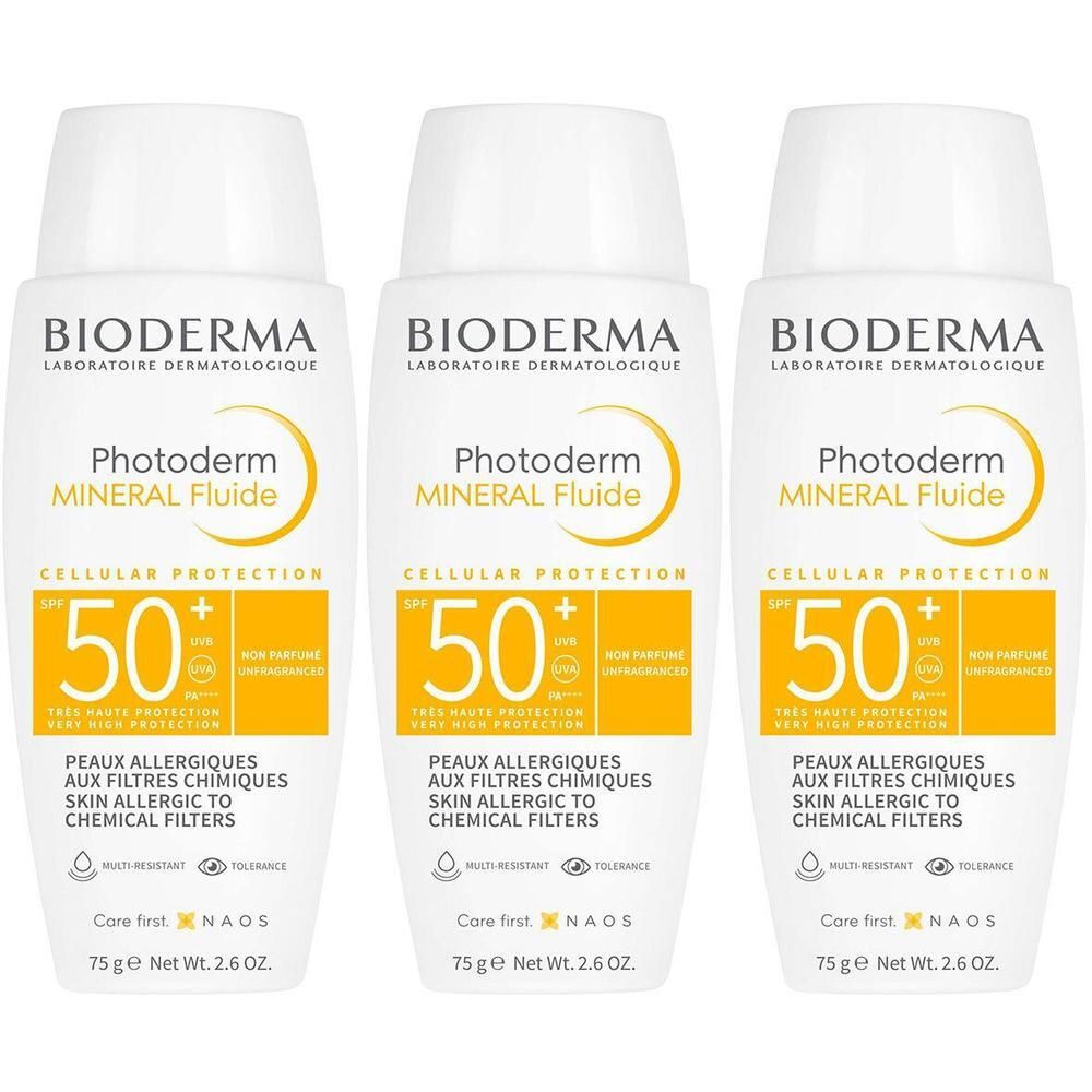 Trois flacons blancs de Bioderma Photoderm Mineral Fluide SPF50+. Étiquettes jaunes avec informations et indice SPF.