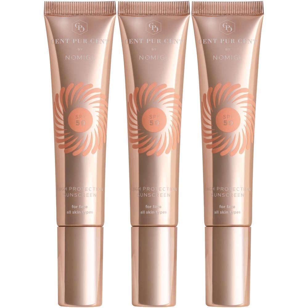 Trois tubes de Cent Pur Cent by Nomige SPF50. Tubes or rose avec logo SPF50 et texte produit. Pour tous types de peau.
