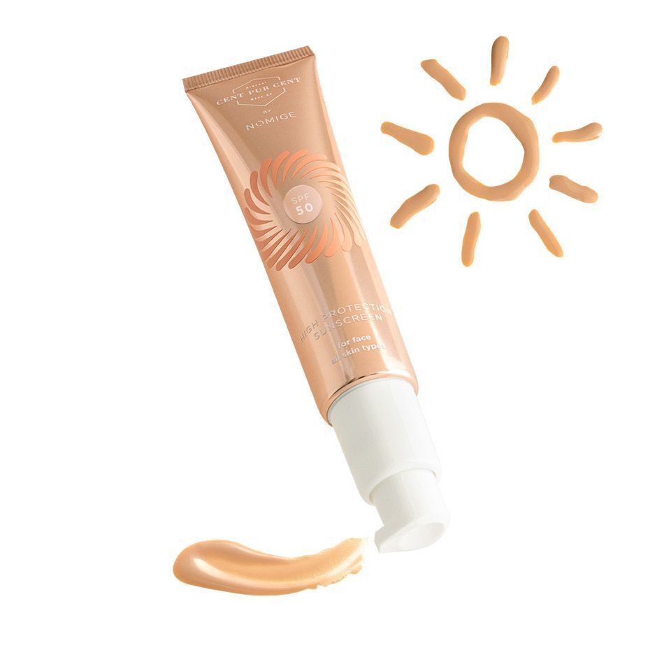Cent Pur Cent by Nomige SPF50 tube. Roségouden tube met SPF50-logo en producttekst. Zonnebrandvlek en zon-illustratie.
