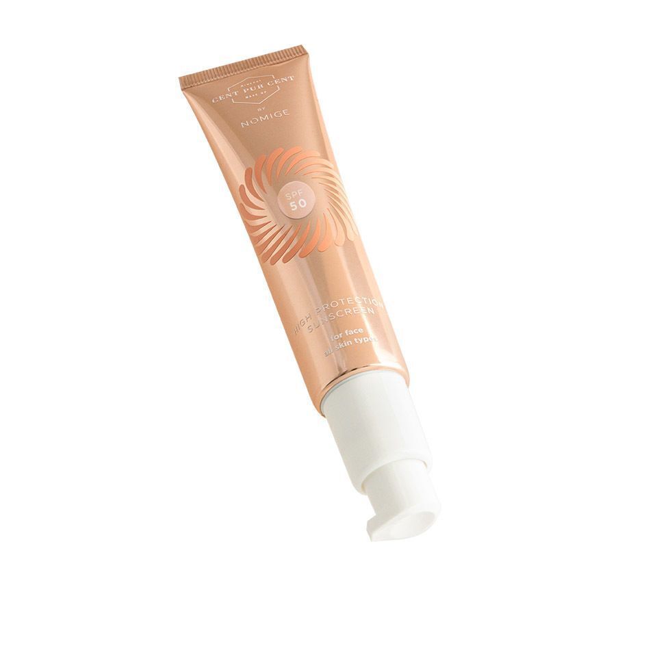 Cent Pur Cent by Nomige SPF50 tube. Roségouden tube met SPF50-logo en producttekst. Zonnebrandvlek.