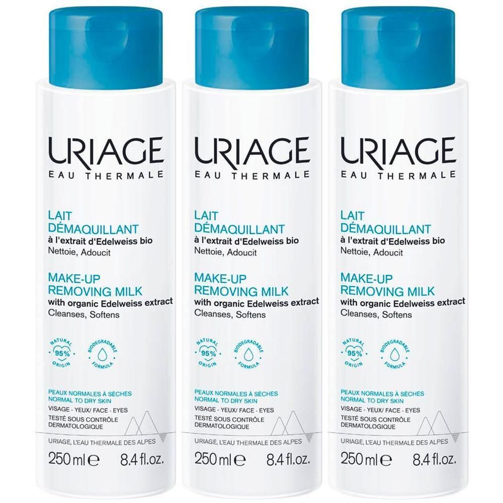 Trois flacons de Lait Démaquillant Uriage. Étiquette blanche, bouchon bleu. Texte: Lait Démaquillant, Make-up Removing Milk.