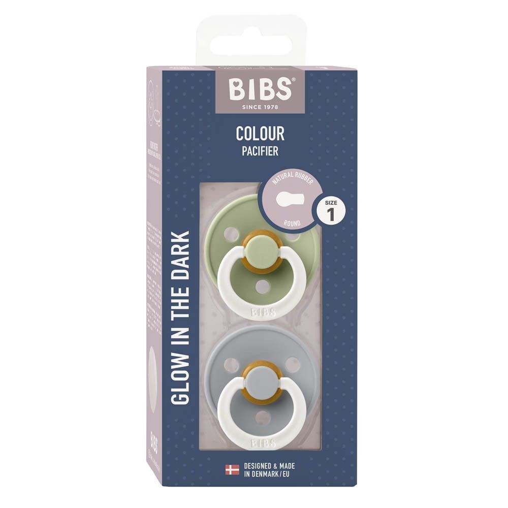 Emballage avec deux sucettes. Vert et gris. Marque BIBS visible, texte : Glow in the Dark, taille 1.