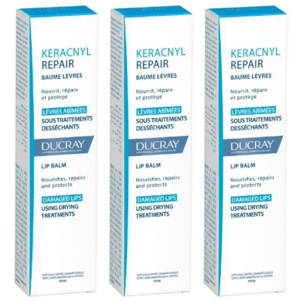 Drie witte dozen met blauwe deksel. Opschrift: Keracnyl Repair Baume Lèvres, voor lippen onder uitdrogende behandeling.