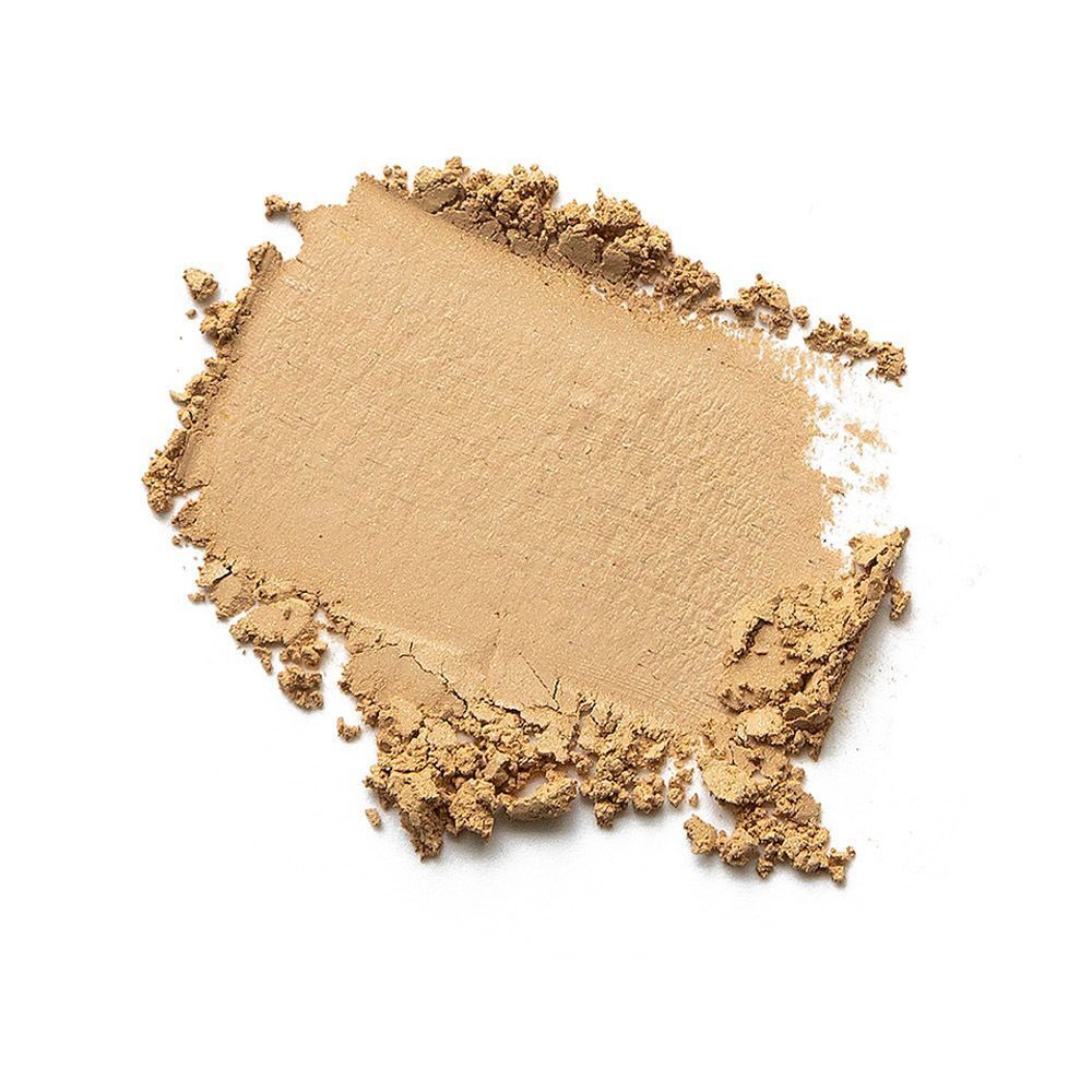 Hoopje lichtbeige poedermake-up. De textuur is korrelig en onregelmatig. De achtergrond is wit.
