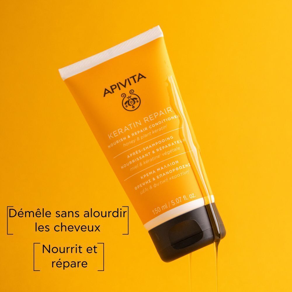Tube de conditionneur jaune. Inscription: Apivita, Keratin Repair. Texte: Démêle, nourrit et répare. Fond jaune.