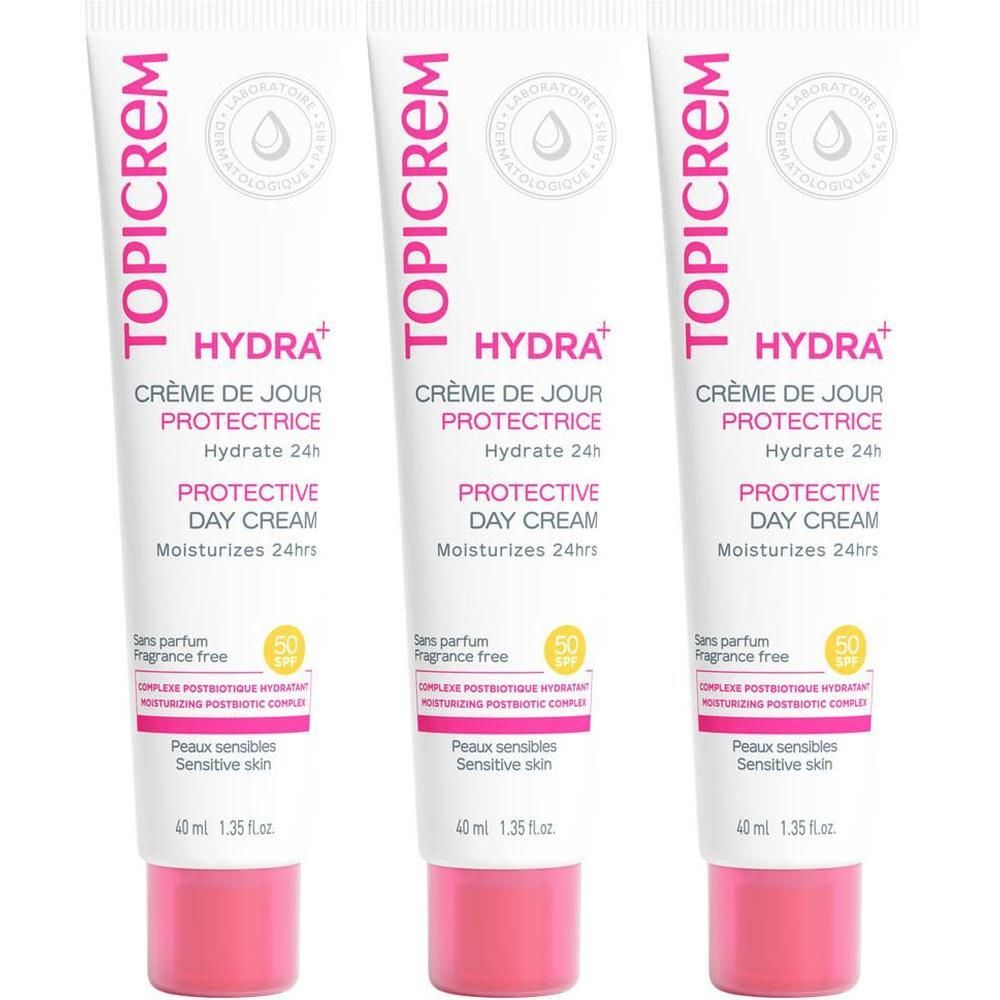 Drie tubes TOPICREM HYDRA+ Crème de jour protectrice SPF50. Witte tubes met roze dop en tekst.