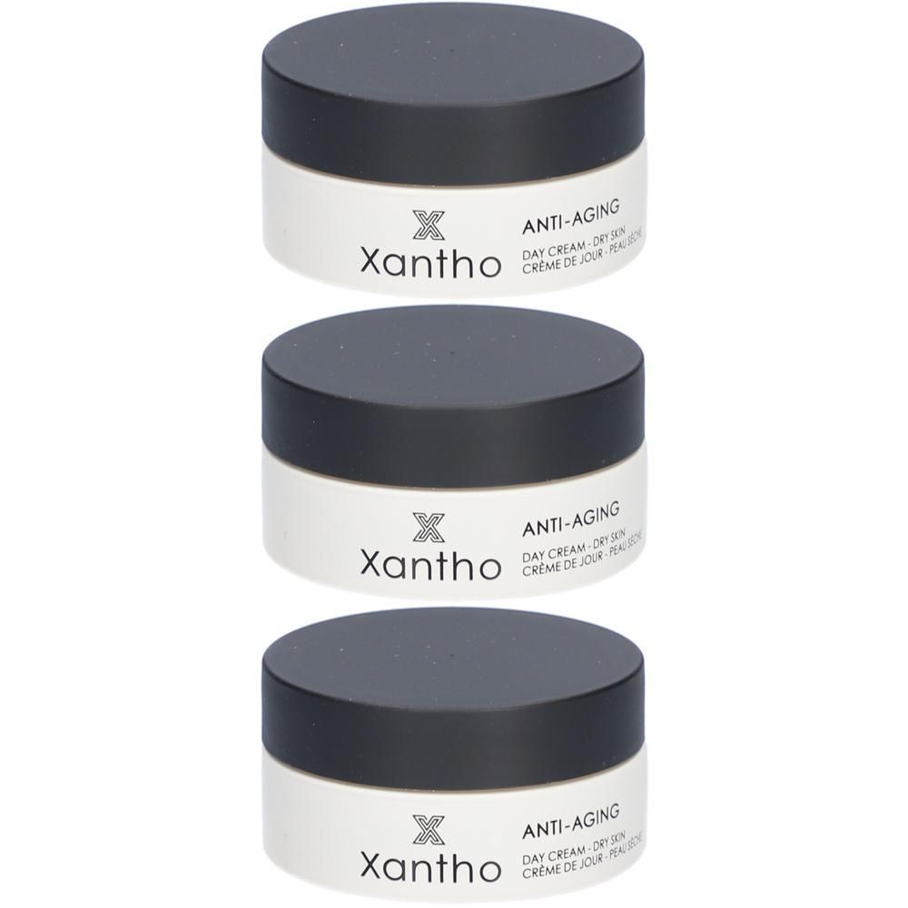 Trois pots de crème de jour anti-âge XANTHO. Pots blancs avec couvercles noirs. Logo et texte visibles.