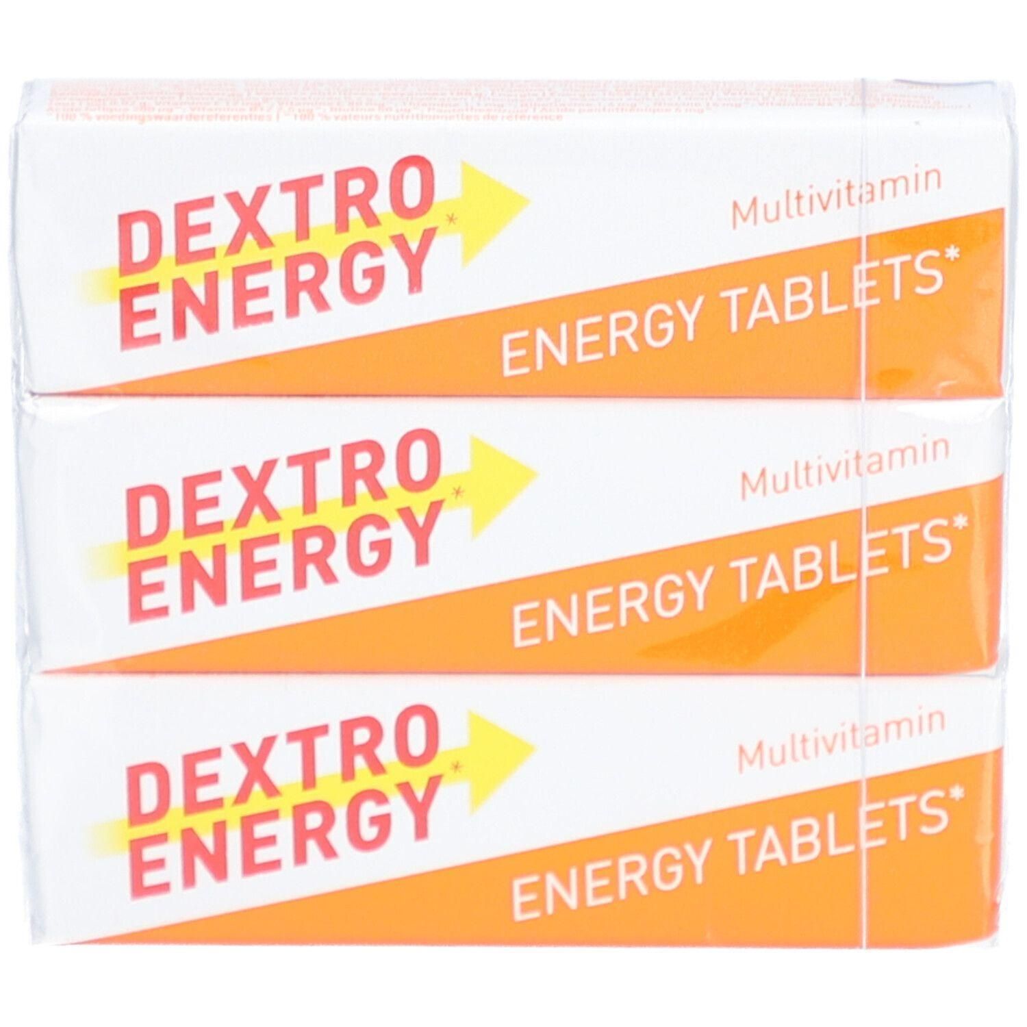 Drie verpakkingen Dextro Energy Multivitamine Energy Tablets. Witte verpakking met oranje streep en gele pijl. Tekst.