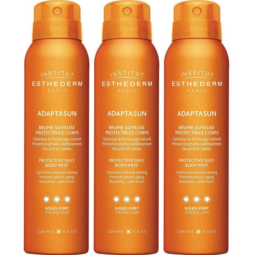 Trois flacons orange. Inscriptions: Institut Esthederm, Adaptasun, Brume Soyeuse Protectrice Corps, Protective Silky Body Mist, Soleil Fort.