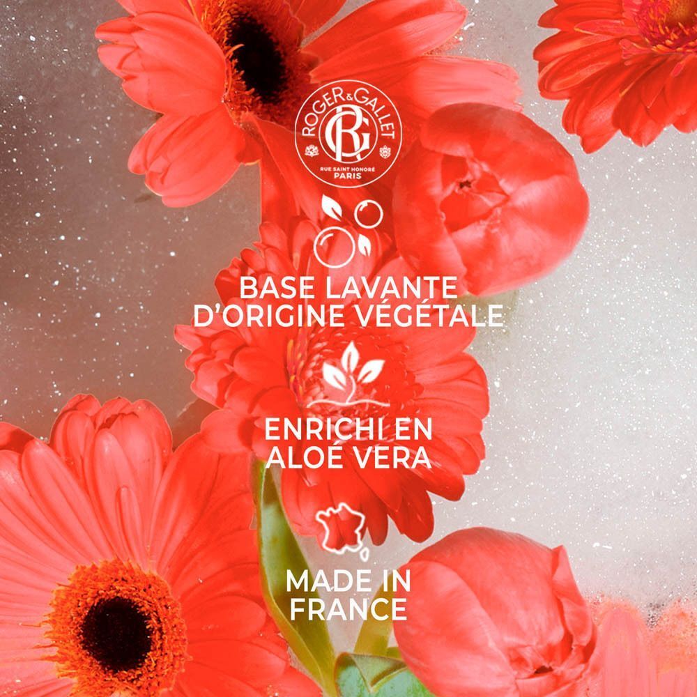 Fleurs rouges dans des bulles de savon. Texte: 'BASE LAVANTE D'ORIGINE VÉGÉTALE'.