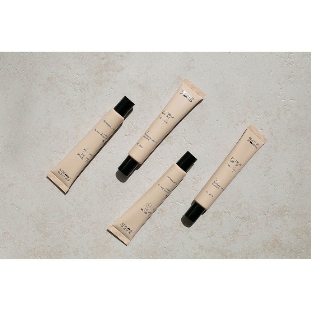 Vier tubes Couleurs de Noir CC CREAM SPF30 01 Porcelain. Beige tubes met zwarte dop. Tekst: CC CREAM SPF 30, UVB + UVA.