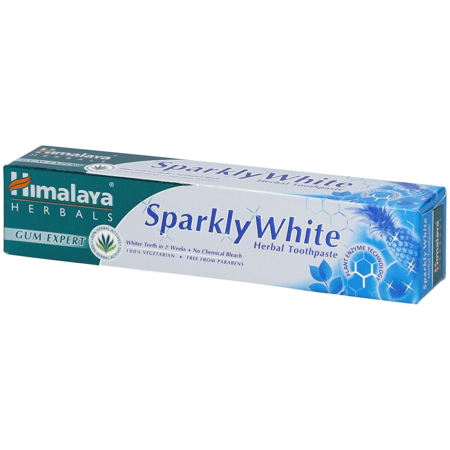 Emballage de dentifrice. Inscription : Himalaya Herbals, Sparkly White. Contient des enzymes végétales. 100% végétarien, sans parabènes.