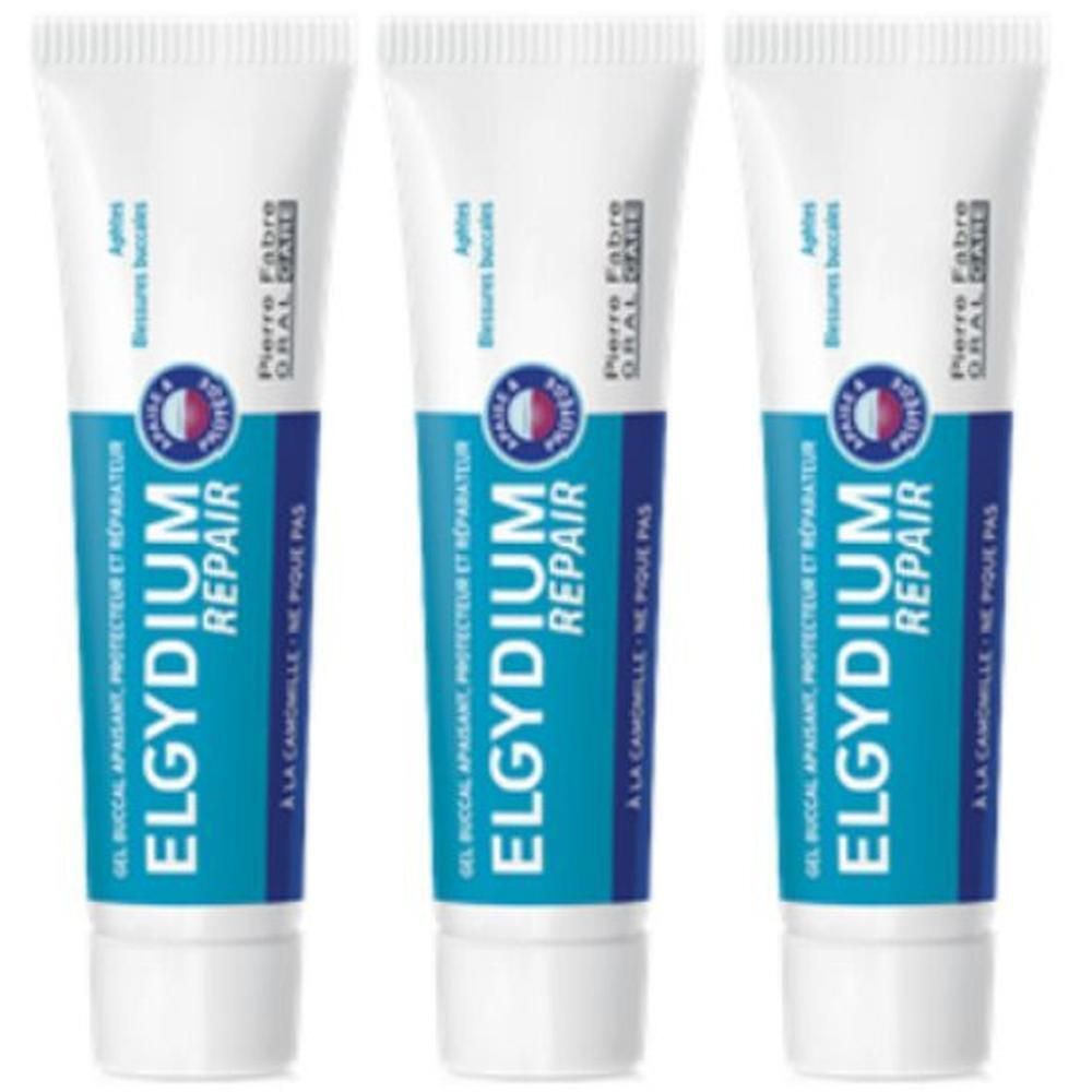 Drie tubes Elgydium Repair gel. Wit en blauwe verpakking met productnaam en logo. Tekst: Gel buccal apaisant, protecteur et réparateur.