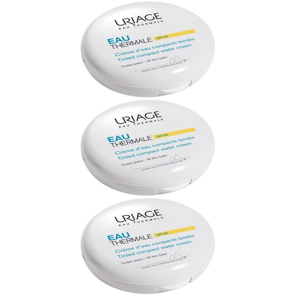 Trois boîtiers blancs ronds. Inscription: Uriage Eau Thermale, Crème d'eau compacte teintée SPF30. Couvercle jaune.