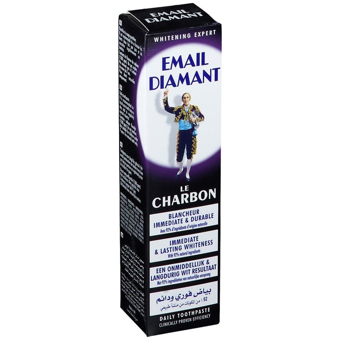 Boîte de dentifrice noire. Marque Email Diamant, texte Le Charbon. Illustration d'une personne. Inscription: Blanchiment immédiat et durable.