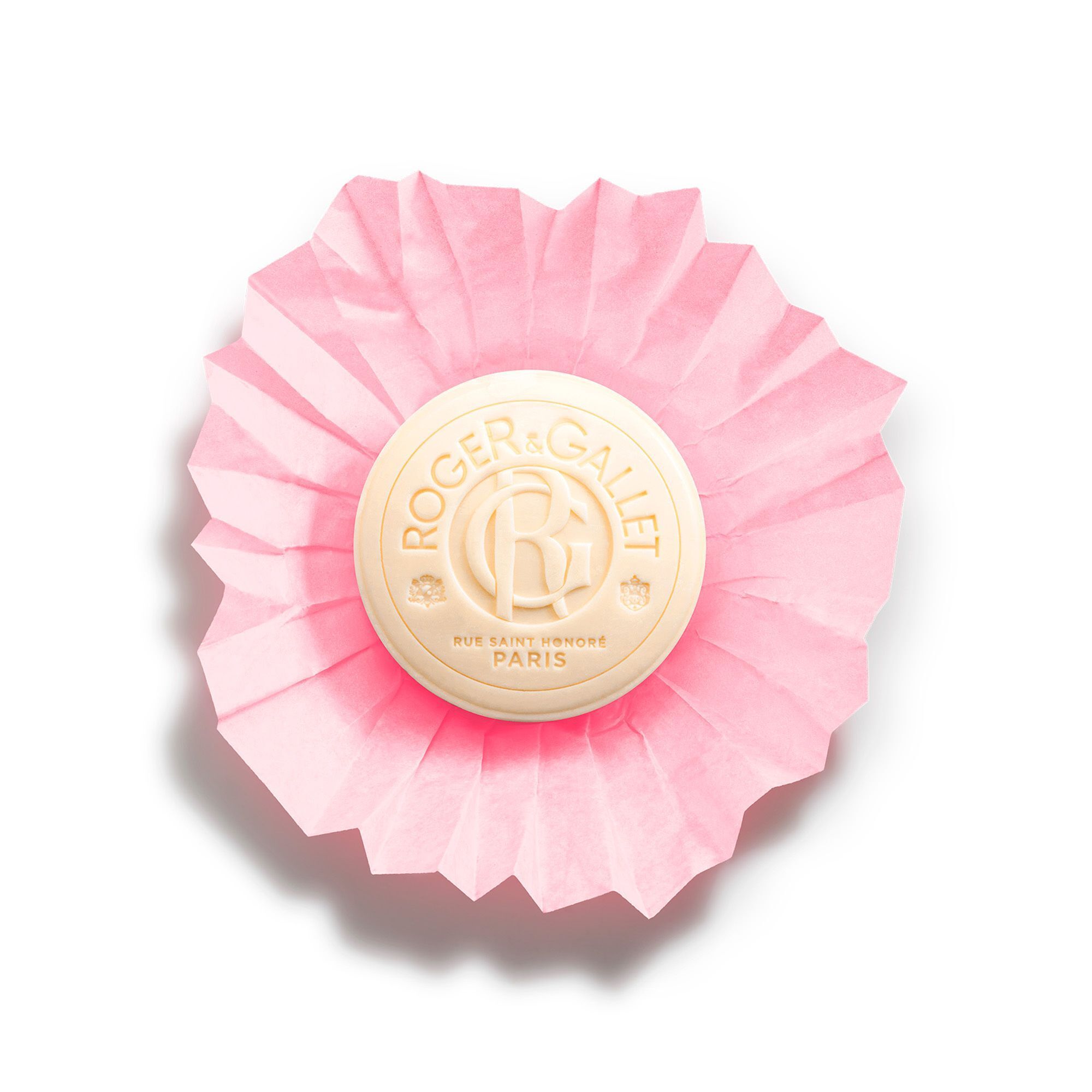 Ronde, crèmekleurige zeep op roze gevouwen papier. Opschrift: Roger & Gallet. Logo en tekst.