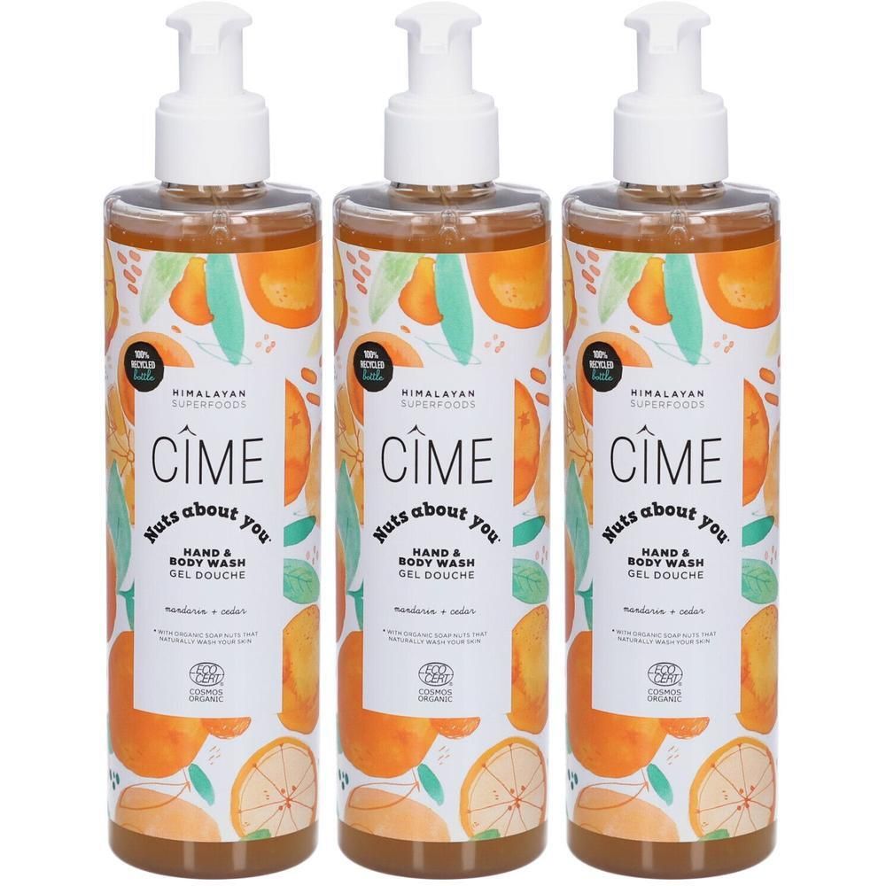 Drie flessen Cîmes hand- en bodywash. Transparante flessen met witte pomp. Etiket met sinaasappel- en bladerenpatroon.