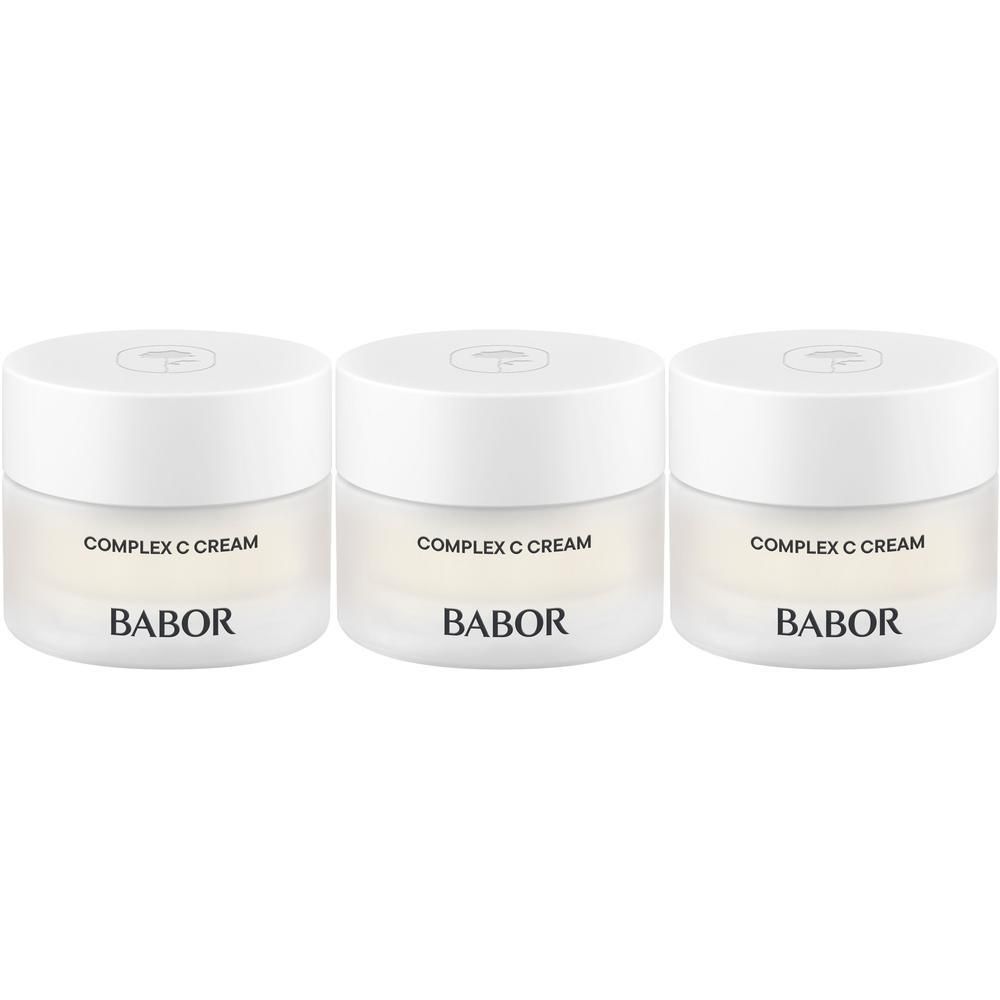 Trois pots de crème Babor Complex C. Couvercles blancs, pots transparents. Inscription: COMPLEX C CREAM, BABOR.