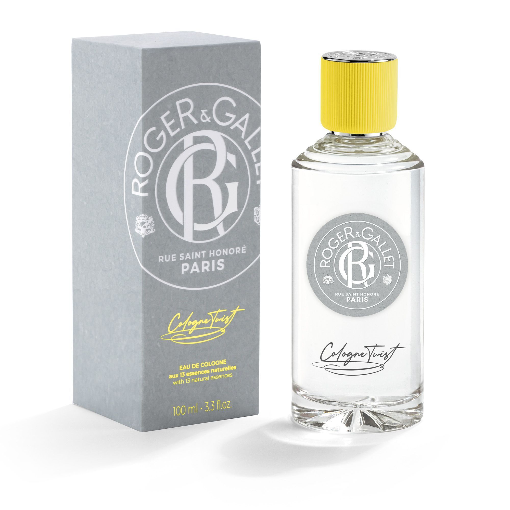 Flesje eau de cologne met verpakking. Grijze doos met logo en opschrift. Flesje met gele dop.