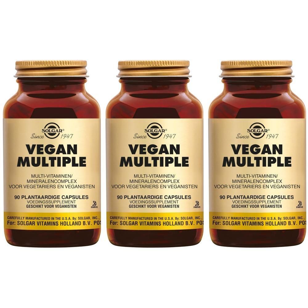 Drie bruine glazen flessen met gouden doppen. Op elke fles staat "Vegan Multiple" en "90 plantaardige capsules".