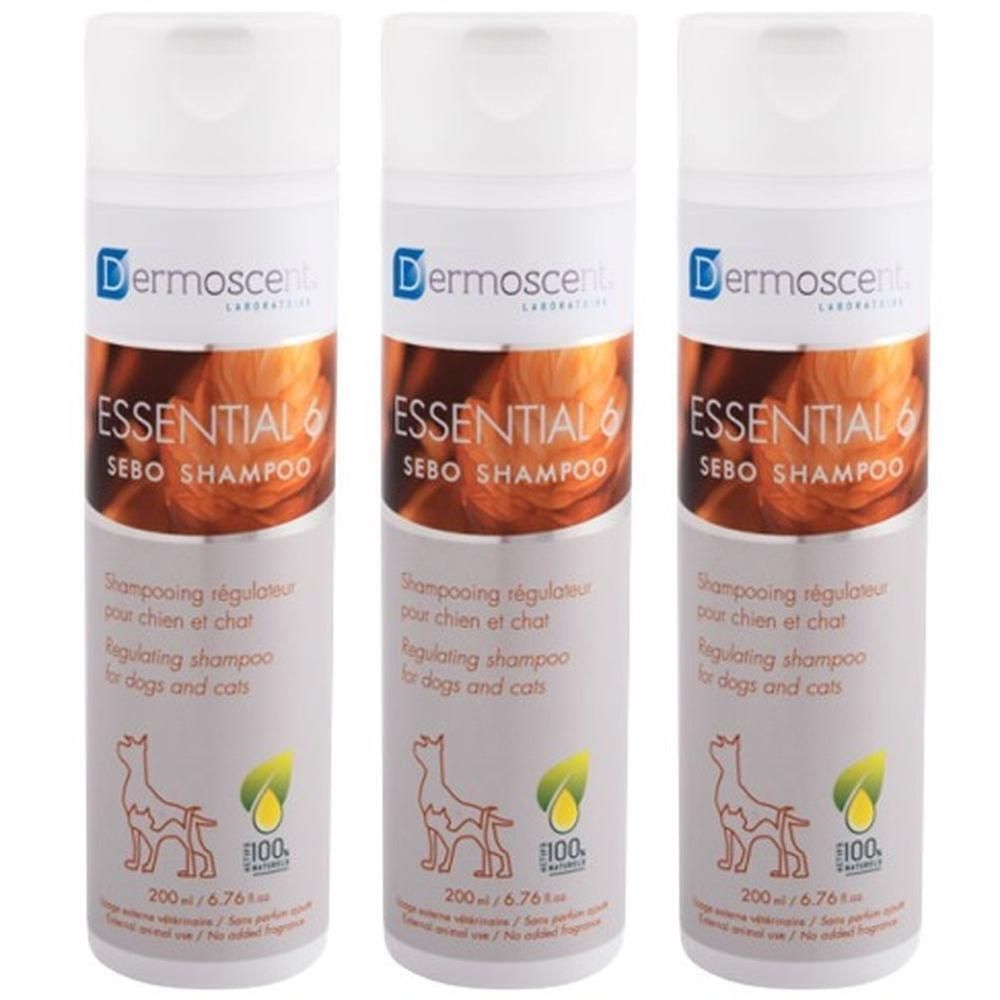 Drie witte shampoo flessen. Etiket: Dermoscent Essential 6 Sebo Shampoo. Bevat afbeeldingen van hond en blad.