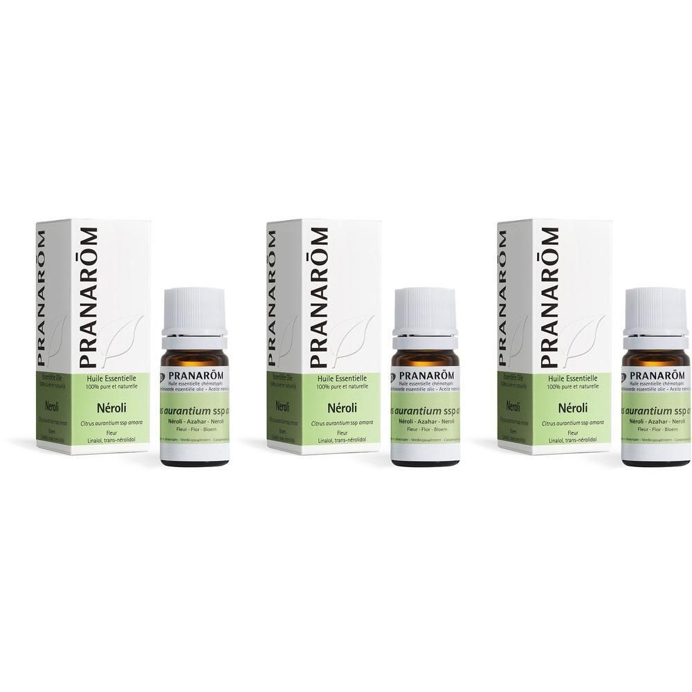 Trois flacons et boîtes de Pranarôm Huile Essentielle Neroli. Flacons blancs avec étiquettes vertes.