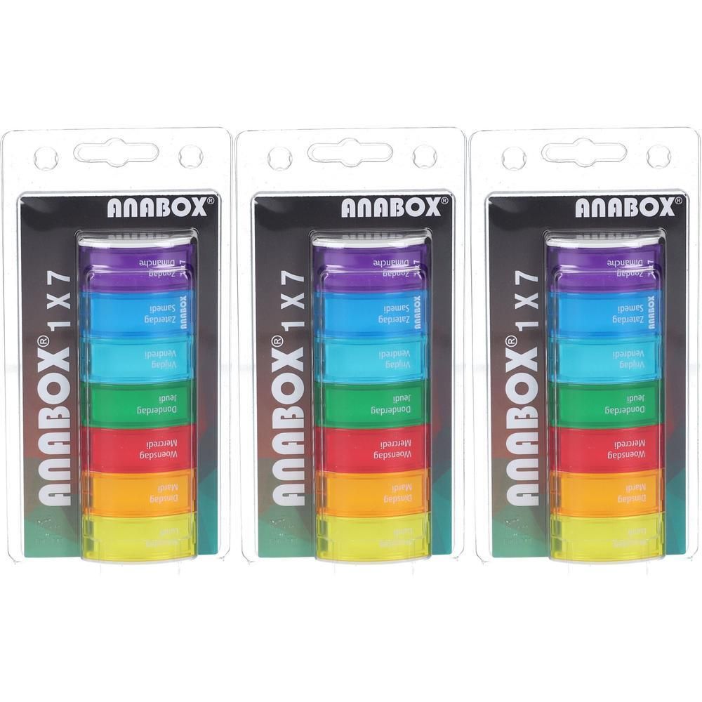Trois piluliers arc-en-ciel emballés. Chaque boîte a sept compartiments et l'inscription "ANABOX 1x7".