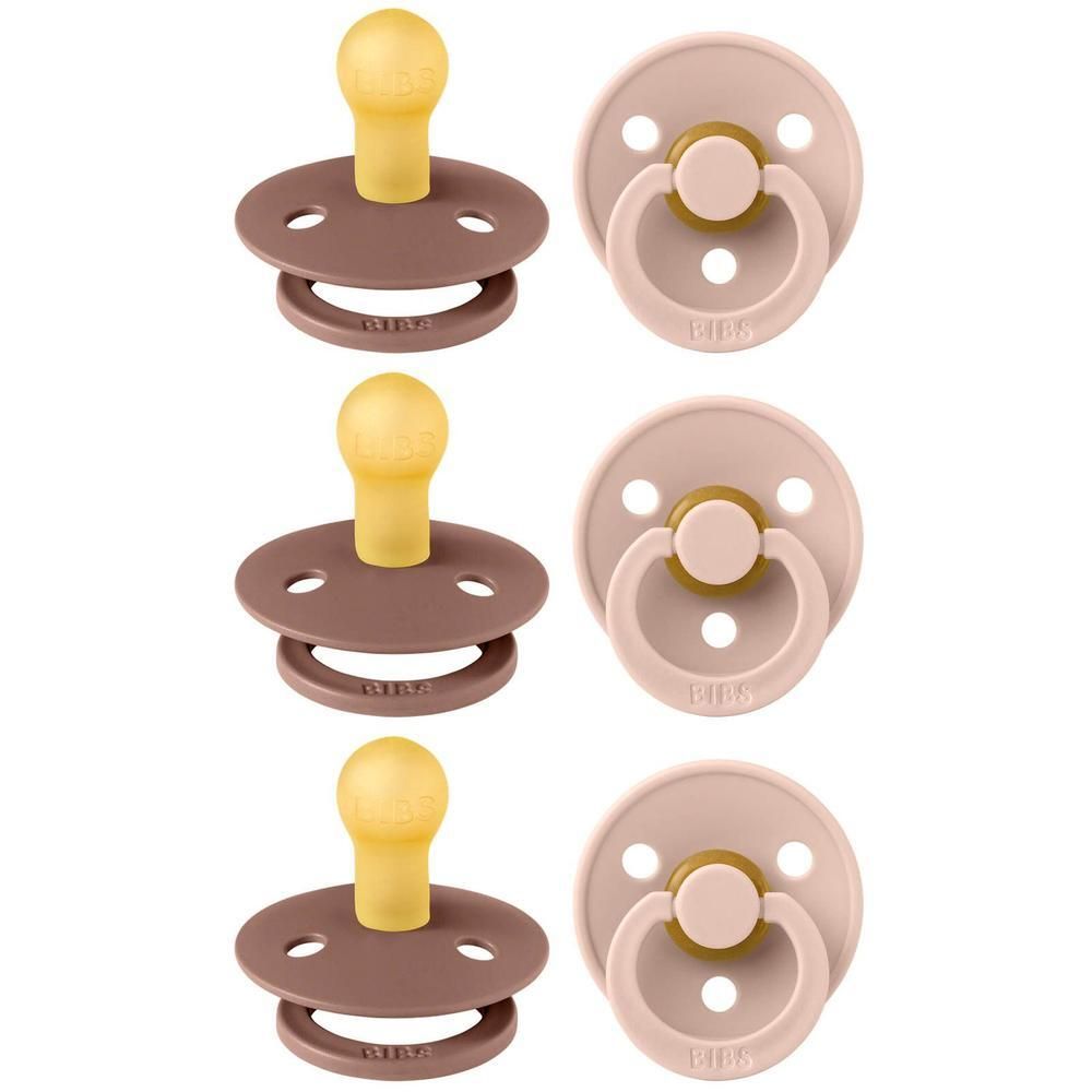 Trois sucettes, deux couleurs : marron et rose. Tétine jaune. Anneaux avec logo BIBS.
