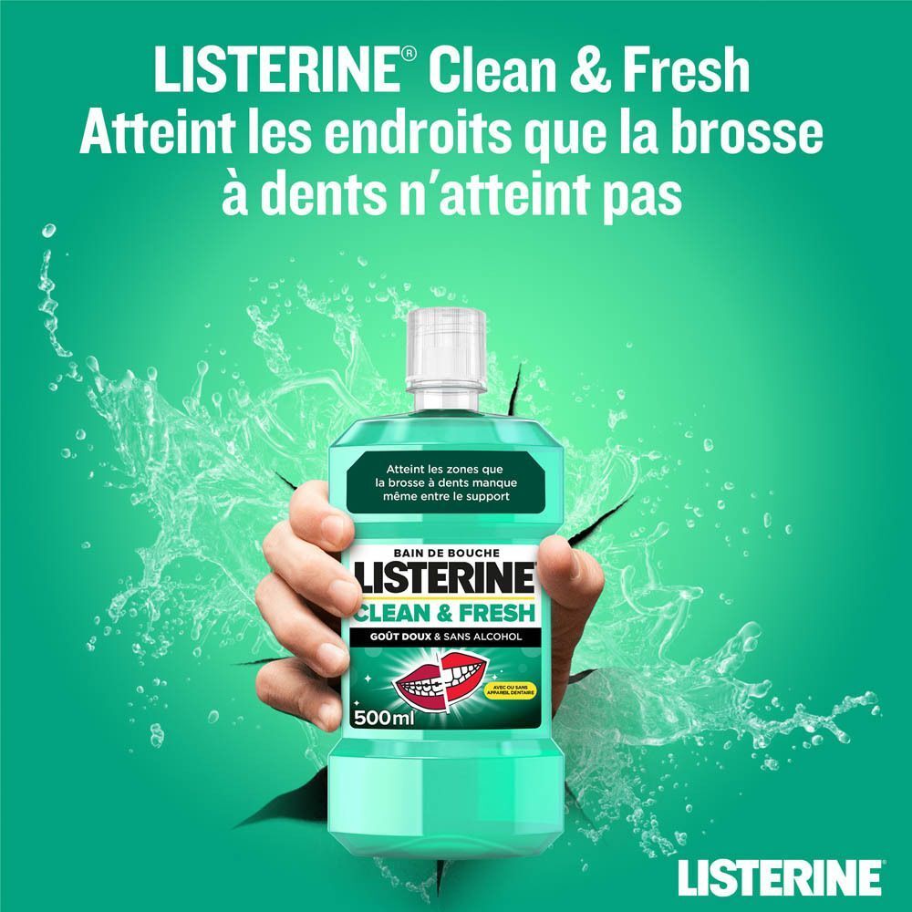 Bouteille de Listerine Clean & Fresh, 500ml, percée par une main. Bain de bouche vert, bouchon blanc.