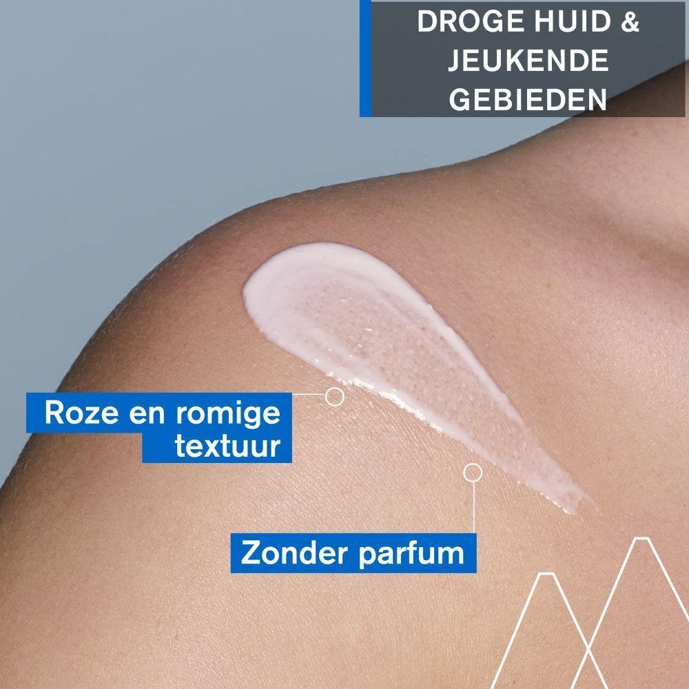 Huid met crème. Roze crème op schouder. Tekst: Roze en romige textuur, Zonder parfum. Blauwe tekst.