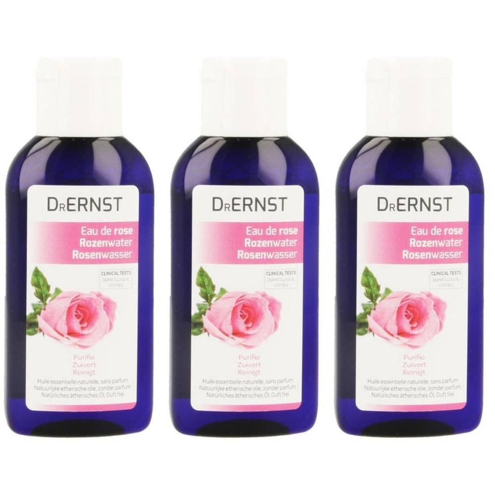 Drie flessen Dr. Ernst Eau de Rose rozenwater. Blauwe flessen met witte dop en etiket met rozenmotief.