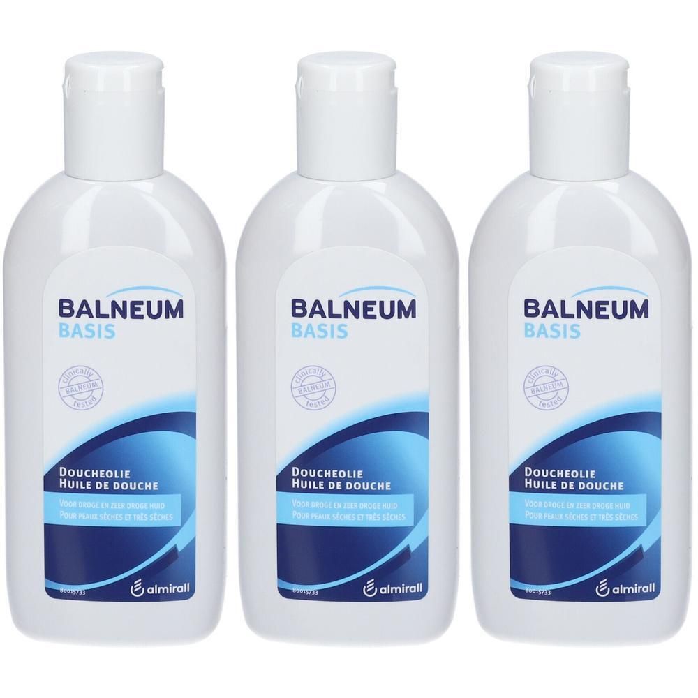 Trois flacons blancs avec bouchons blancs. Chaque flacon porte l'inscription "BALNEUM BASIS" et "DOUCHEOLIE Huile de Douche".