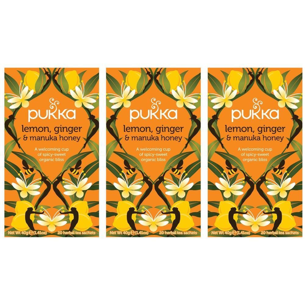 Trois boîtes de thé Pukka. Sur fond orange, l'inscription "lemon, ginger & manuka honey". Motif floral avec fleurs et feuilles jaunes.