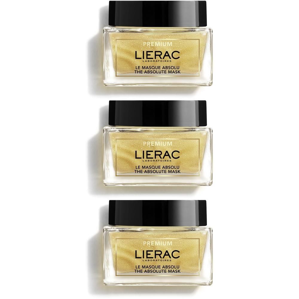 Drie potten Lierac Premium Le Masque Absolu. Glazen potten met zwarte deksels. Gouden inhoud, productnaam zichtbaar.