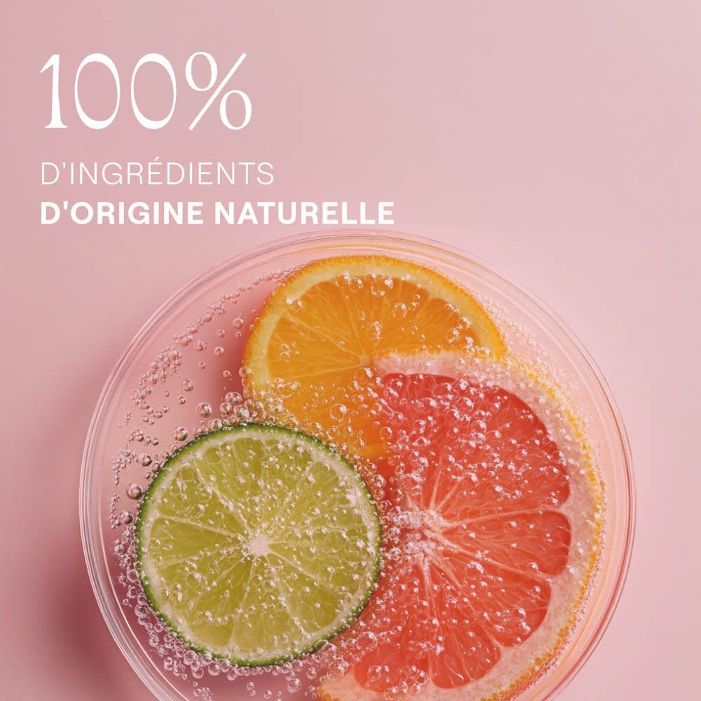 Tranches de citron et de pamplemousse dans un bol en verre. Texte : "100% d'ingrédients naturels".
