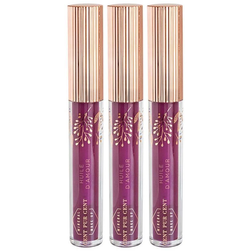 Drie Lip Oil flacons met gouden doppen. Op elke fles staat "Cent Pur Cent" en "Huile d'Amour". 