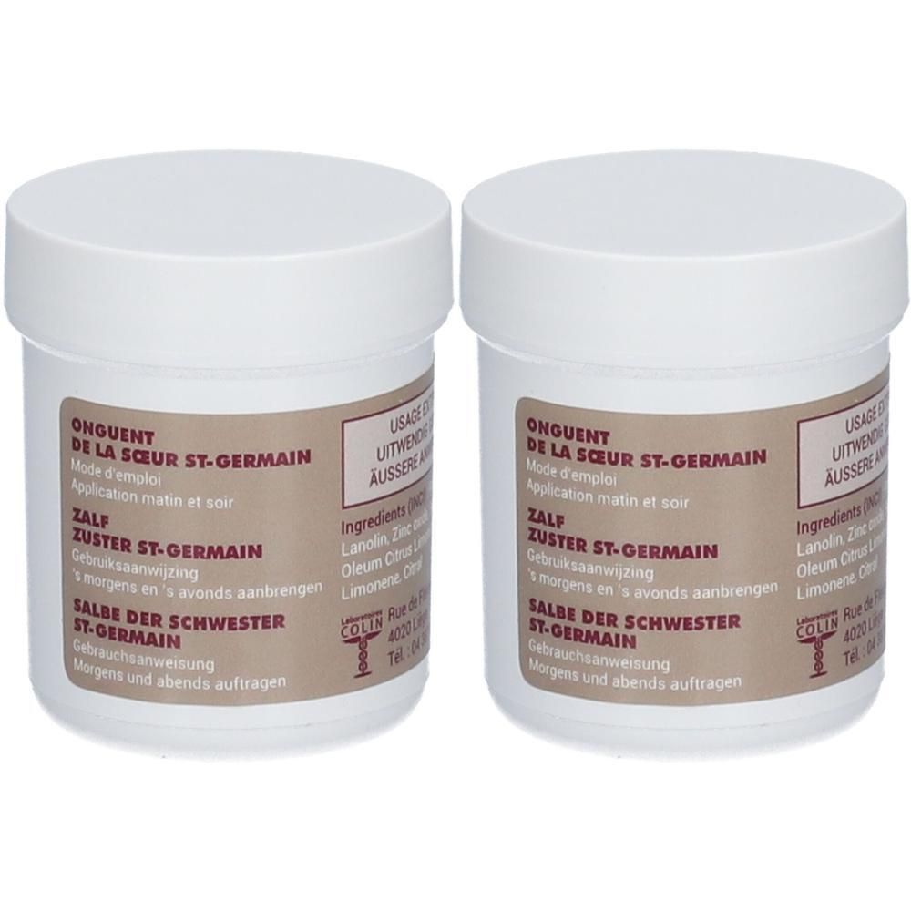 Deux pots blancs de l'onguent de la Sœur St-Germain. Étiquettes avec informations produit et ingrédients.