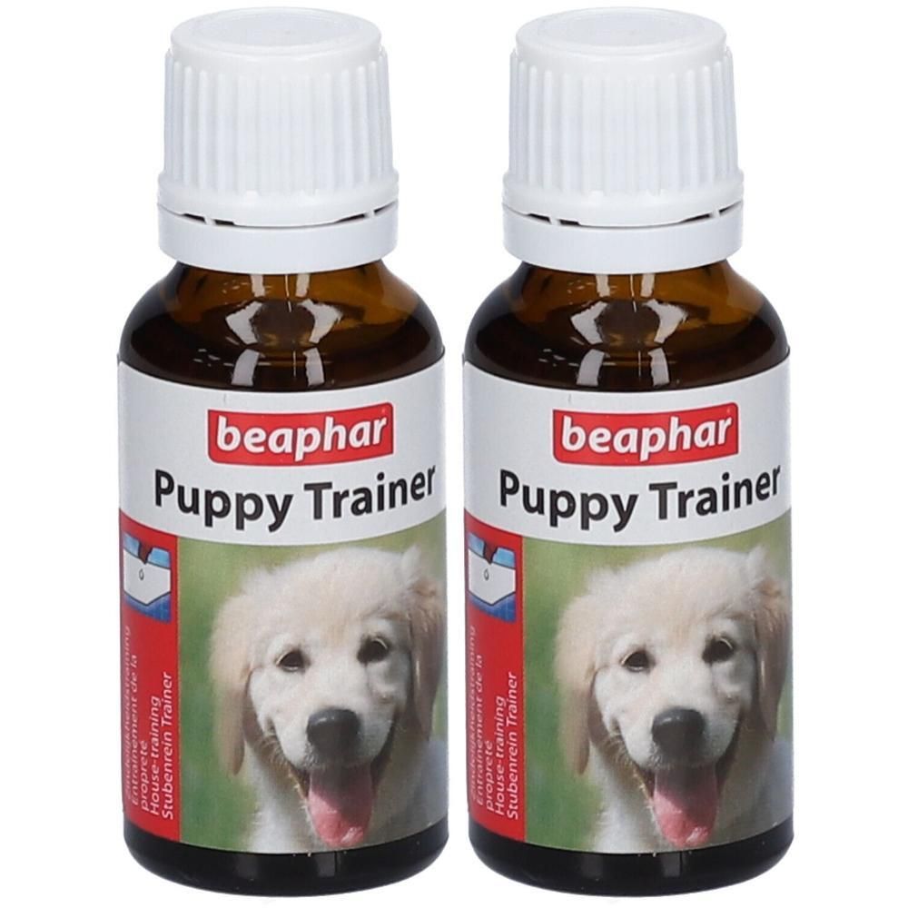 Deux flacons en verre brun avec bouchon blanc, Beaphar Puppy Trainer, avec image de chiot.
