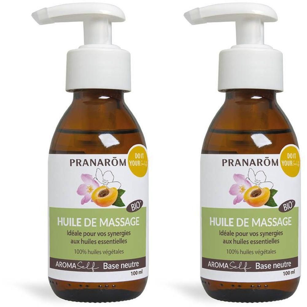 Twee flessen Pranarôm massageolie met pompdispenser. Bruin glas, etiket met perzik en bloesem.