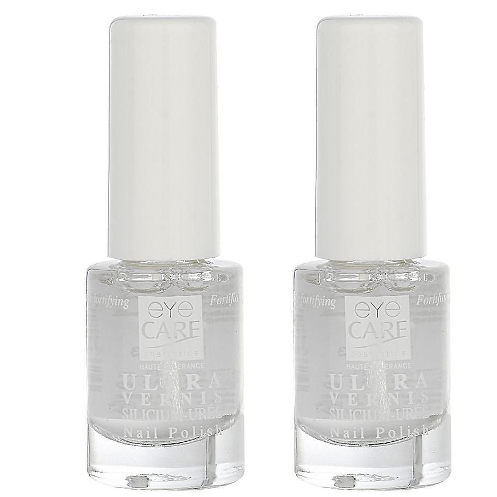 Deux flacons de vernis à ongles transparent avec bouchons blancs. L'étiquette indique 'EYE CARE ULTRA VERNIS SILICIUM-URÉE Nail Polish'.