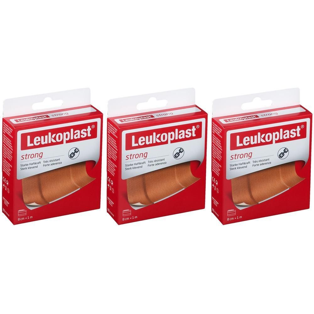 Trois boîtes de Leukoplast strong. Emballage rouge avec logo blanc et nom du produit. Bandages visibles.